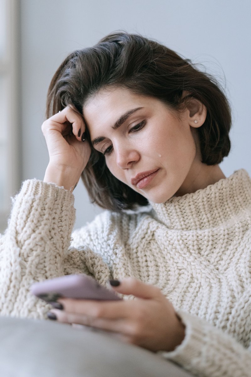 A Woman Crying While Looking at Her Phone · Free Stock Photo