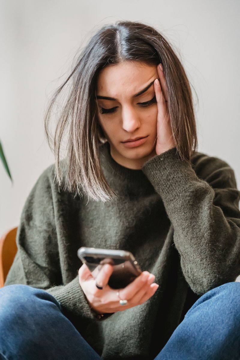 A Woman Crying While Looking at Her Phone · Free Stock Photo