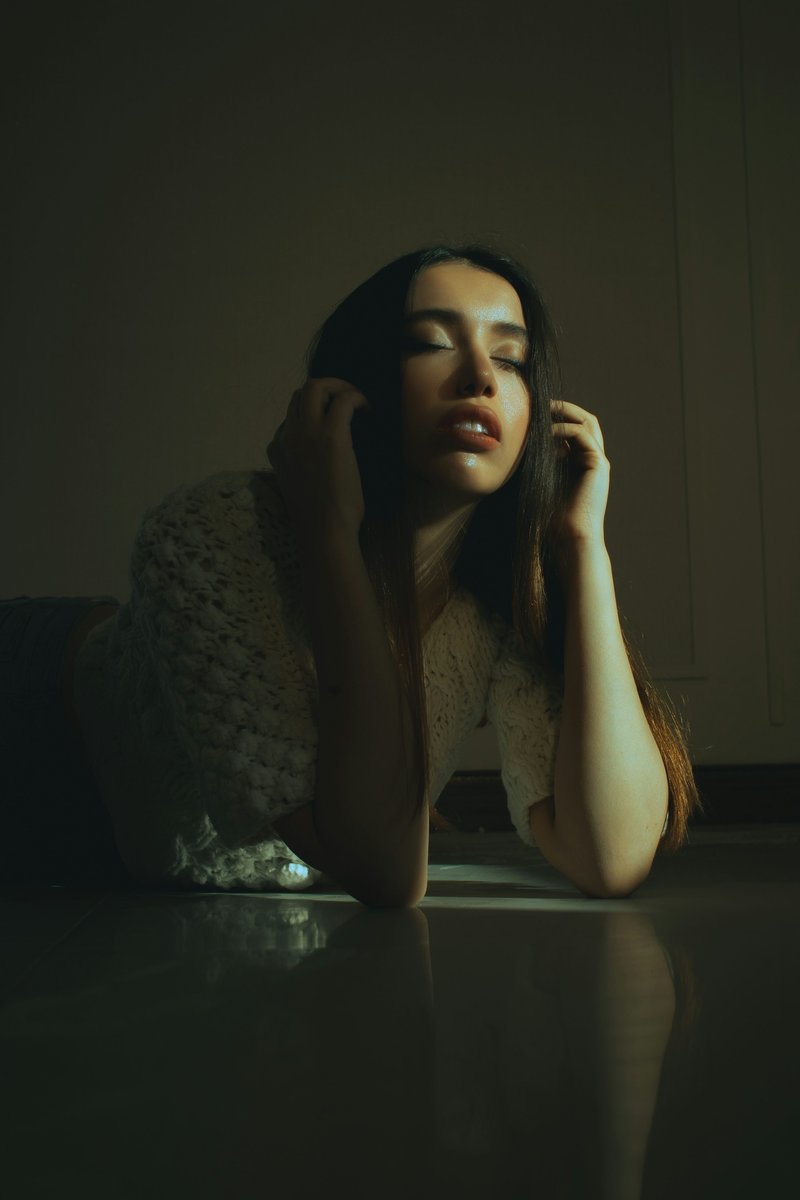 A woman laying on the floor with her head on her hand photo ... A woman laying on the floor with her head on her hand photo ...