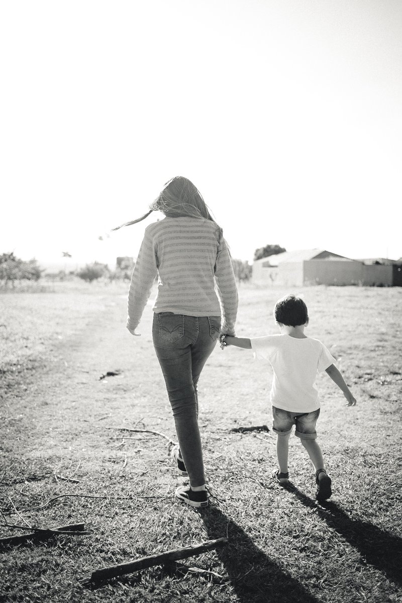 Grayscale Photo of Mother and Son Standing on Boardwalk · Free Stock Photo Grayscale Photo of Mother and Son Standing on Boardwalk · Free Stock Photo