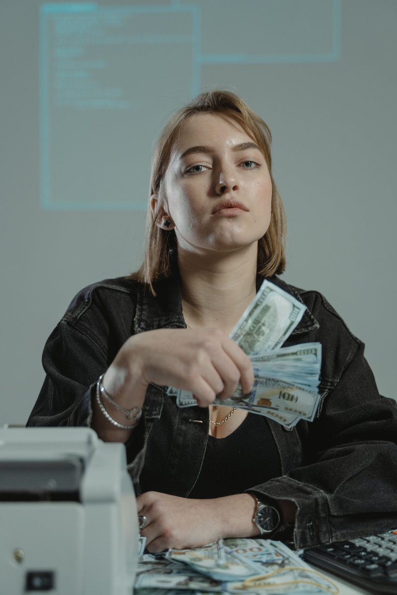 Person Holding a Bundle of Money · Free Stock Photo