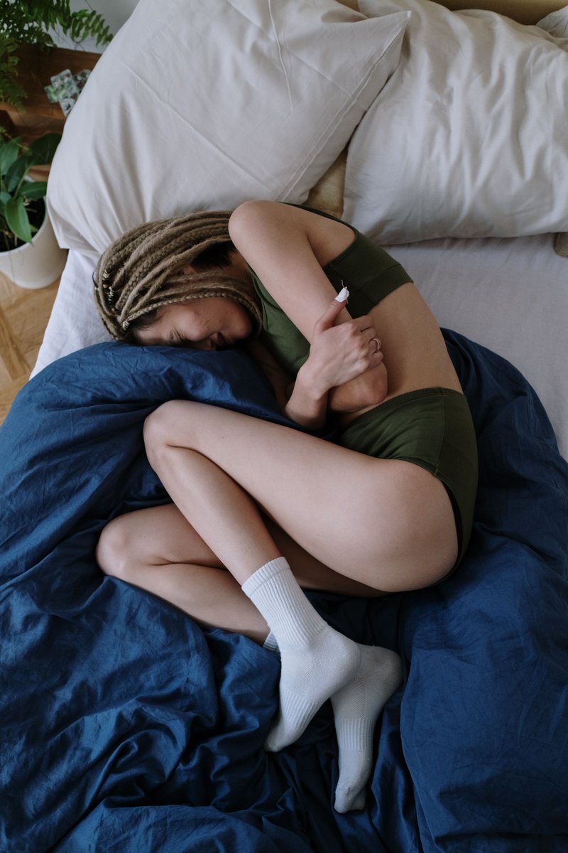 Woman Suffering from a Stomach Pain Lying Down on Bed · Free Stock Photo Woman Suffering from a Stomach Pain Lying Down on Bed · Free Stock Photo