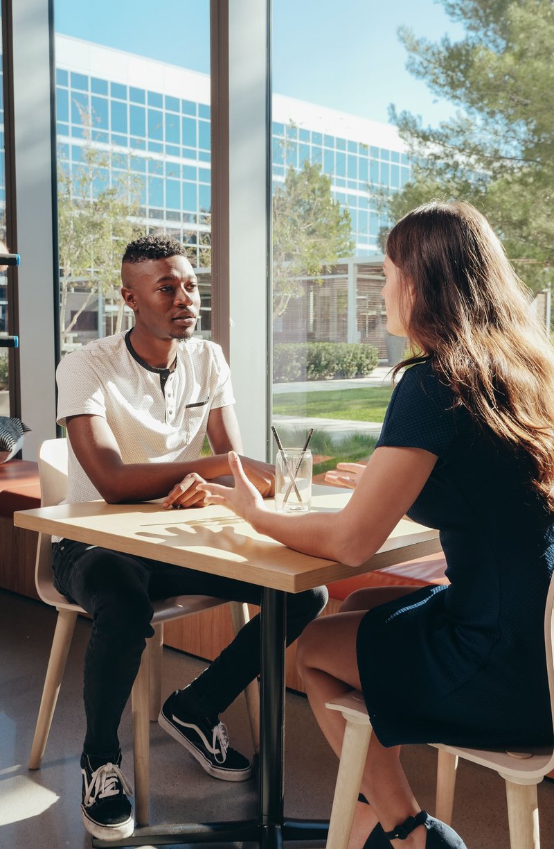 A Man and a Woman Talking while Sitting Down · Free Stock Photo A Man and a Woman Talking while Sitting Down · Free Stock Photo