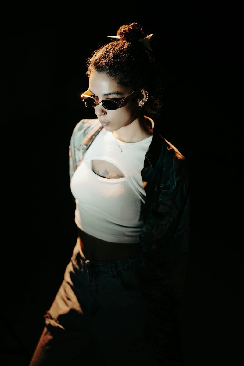 A woman wearing sunglasses and a white top. photo – Free Green Image on Unsplash