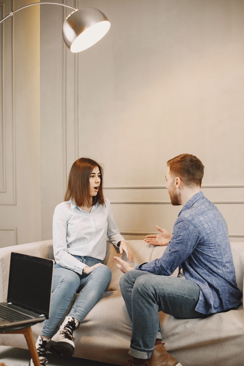 Close-Up Shot of a Man and a Woman Talking while Sitting on a Couch · Free Stock Photo Close-Up Shot of a Man and a Woman Talking while Sitting on a Couch · Free Stock Photo