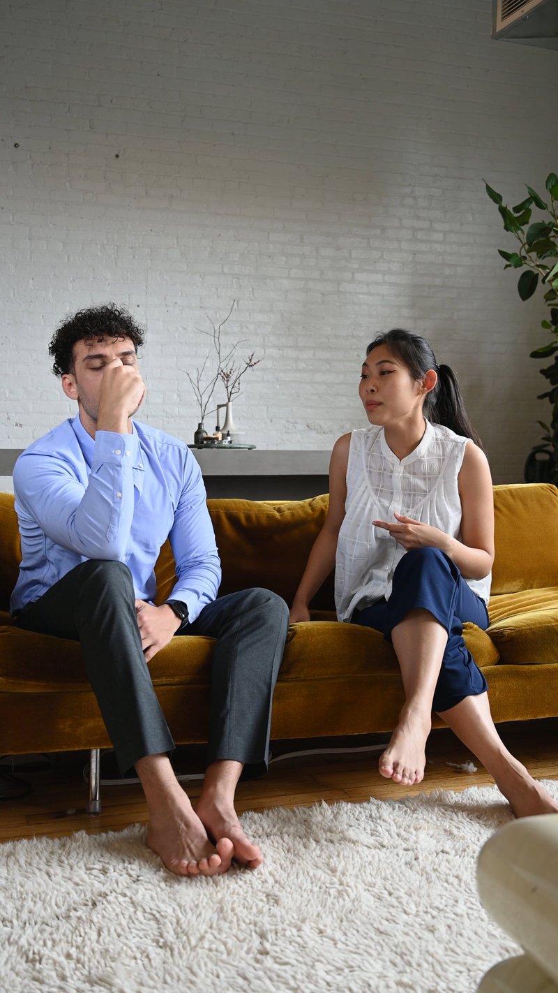 Couple Fighting while Sitting in a Sofa Couple Fighting while Sitting in a Sofa
