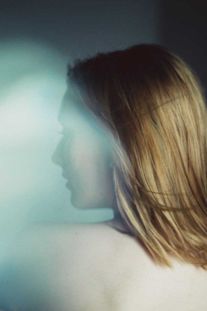 Dark Abstract Photograph of a Woman with Blond Hair · Free Stock Photo