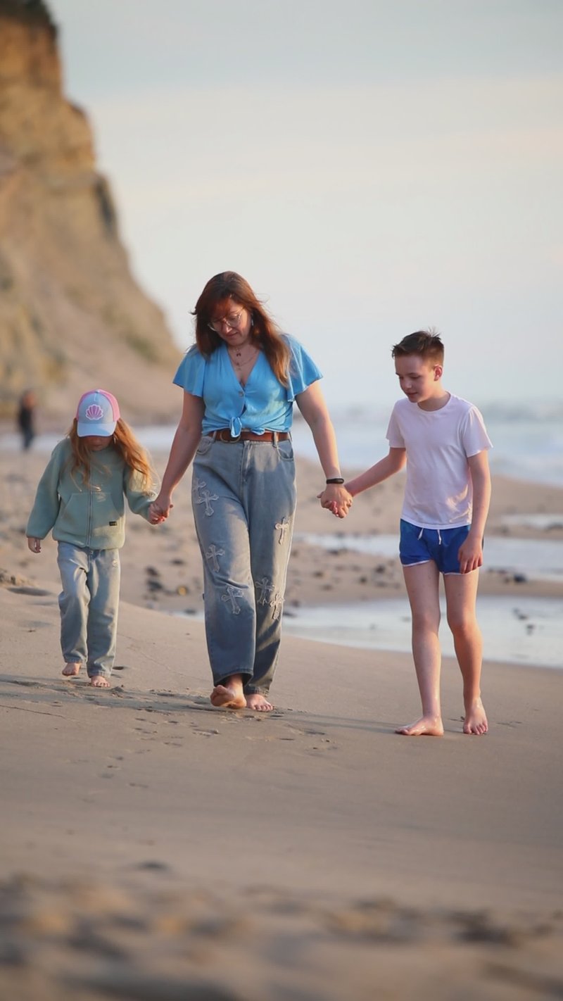 Family Walks Along Scenic Beach at Sunset