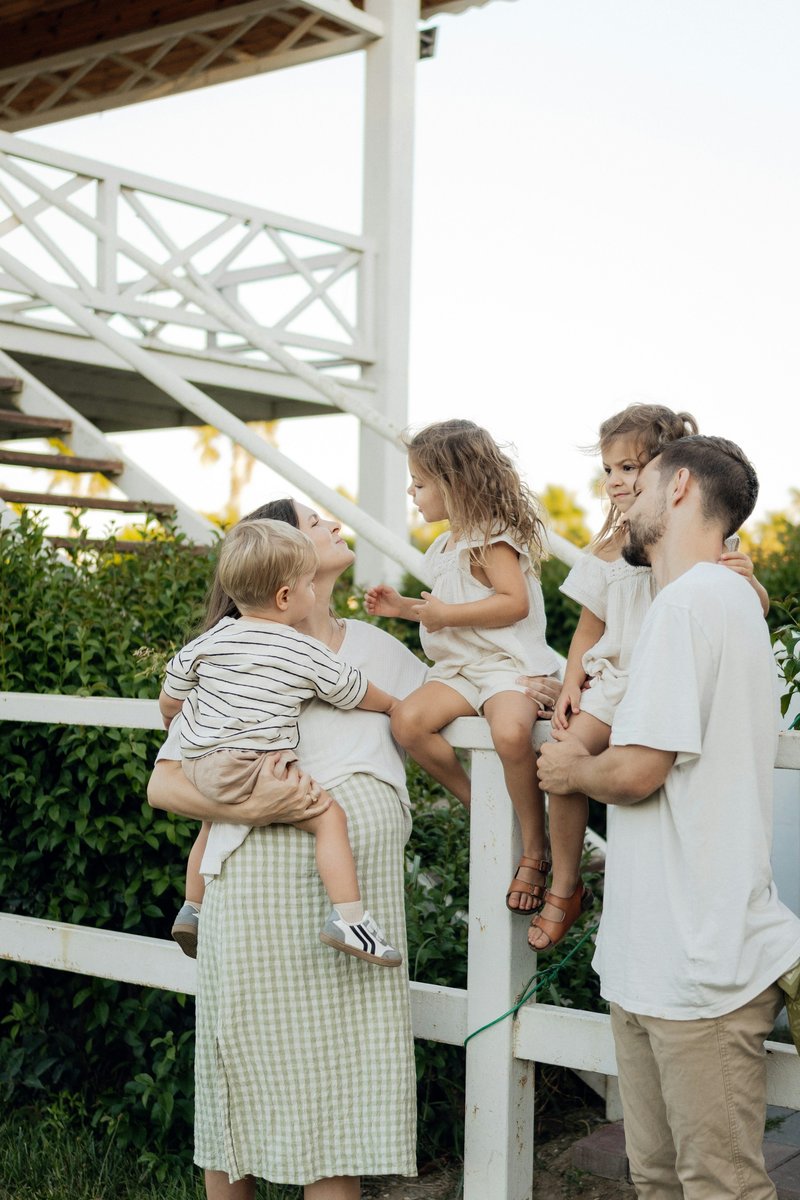 Family enjoying time together on a porch. photo &ndash; Free White ...