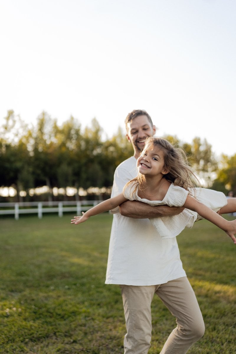 Father and Daughter Playing Joyfully Outdoors &middot; Free Stock Photo
