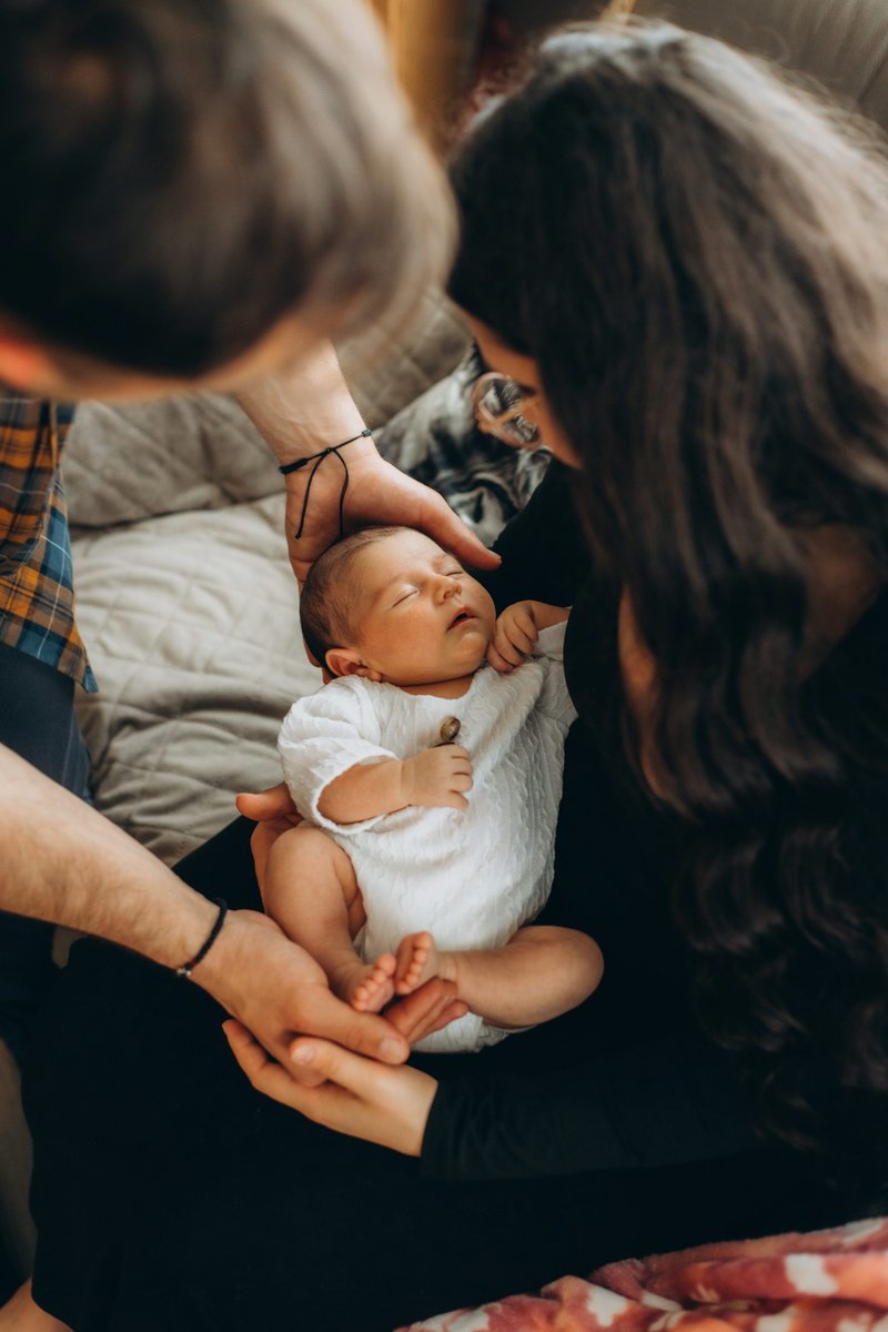 Parents lovingly hold their sleeping newborn baby. photo &ndash; Free Portrait  Image on Unsplash
