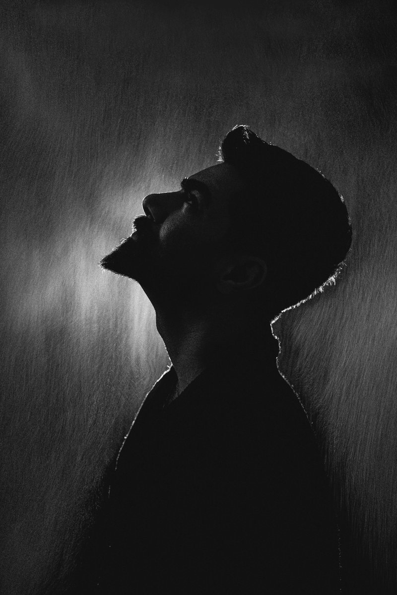 Silhouette of a man looking up in the rain - Free Photo on Unsplash