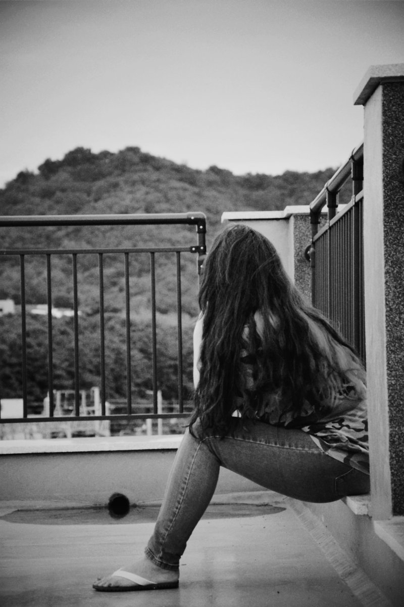 Woman Sitting Alone on Balcony · Free Stock Photo Woman Sitting Alone on Balcony · Free Stock Photo