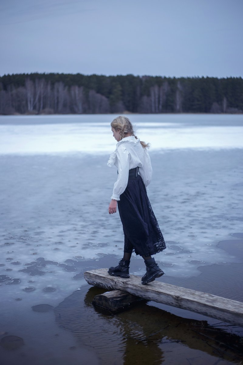 Woman Standing on a Wooden Board on the Shore of a Frozen ...