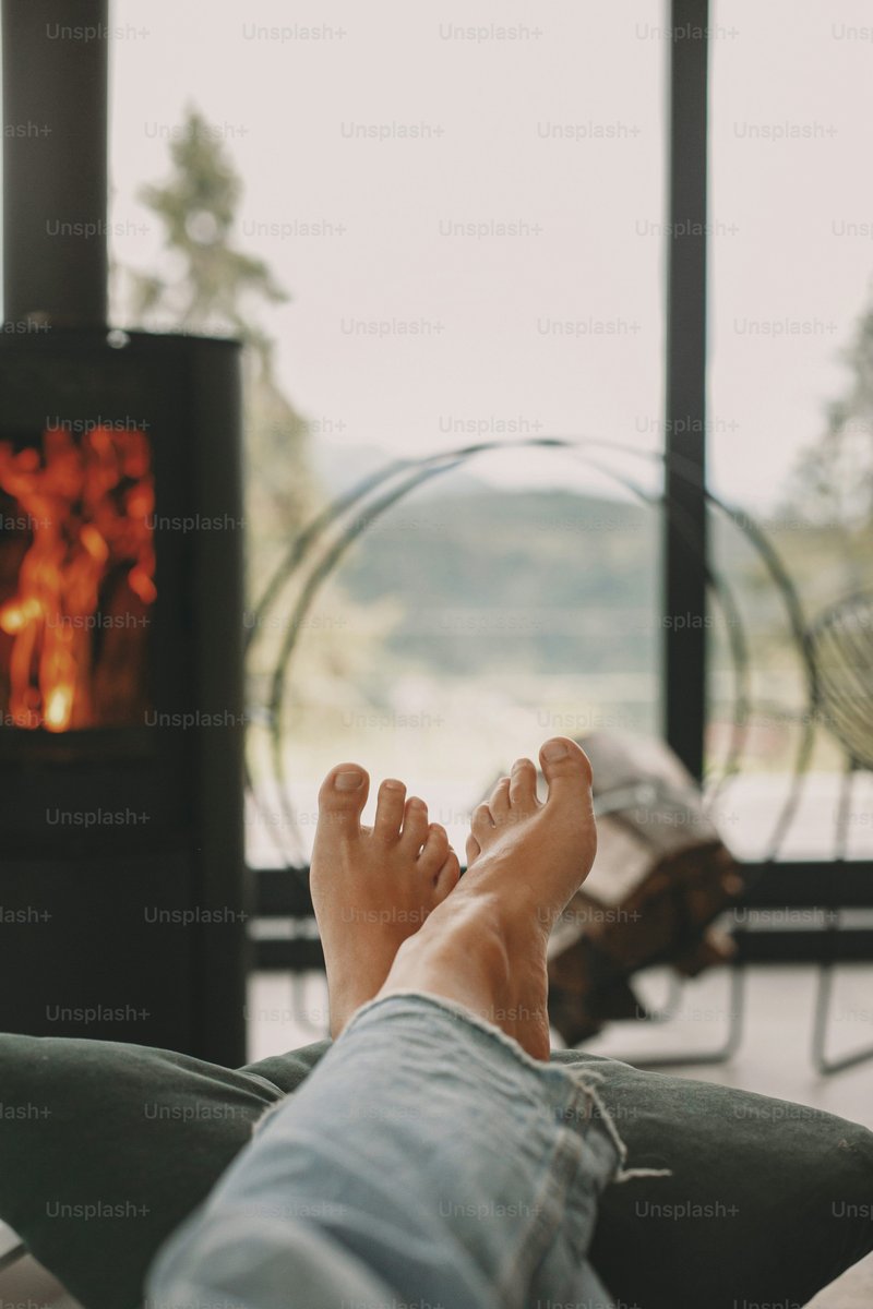 Woman barefoot relaxing in comfortable home, cozy warm ... Woman barefoot relaxing in comfortable home, cozy warm ...