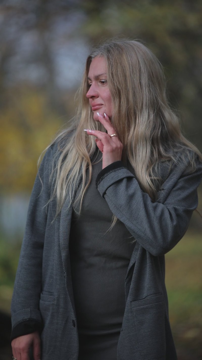 Woman in Autumn Park Smoking and Reflecting