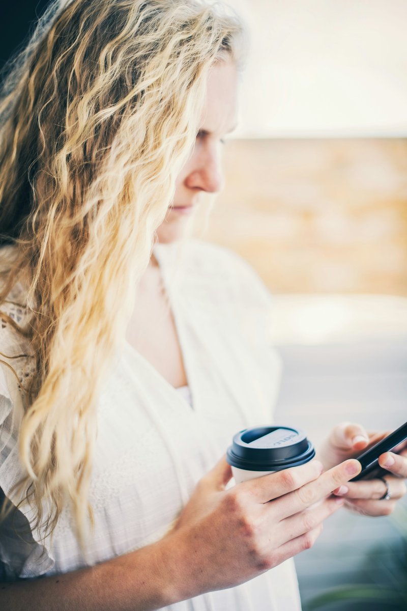 Woman in white shirt holding black cup photo – Free Woman Image on Unsplash