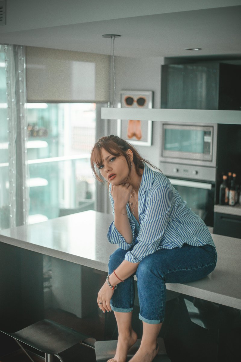 Woman sitting in kitchen photo – Free Image on Unsplash