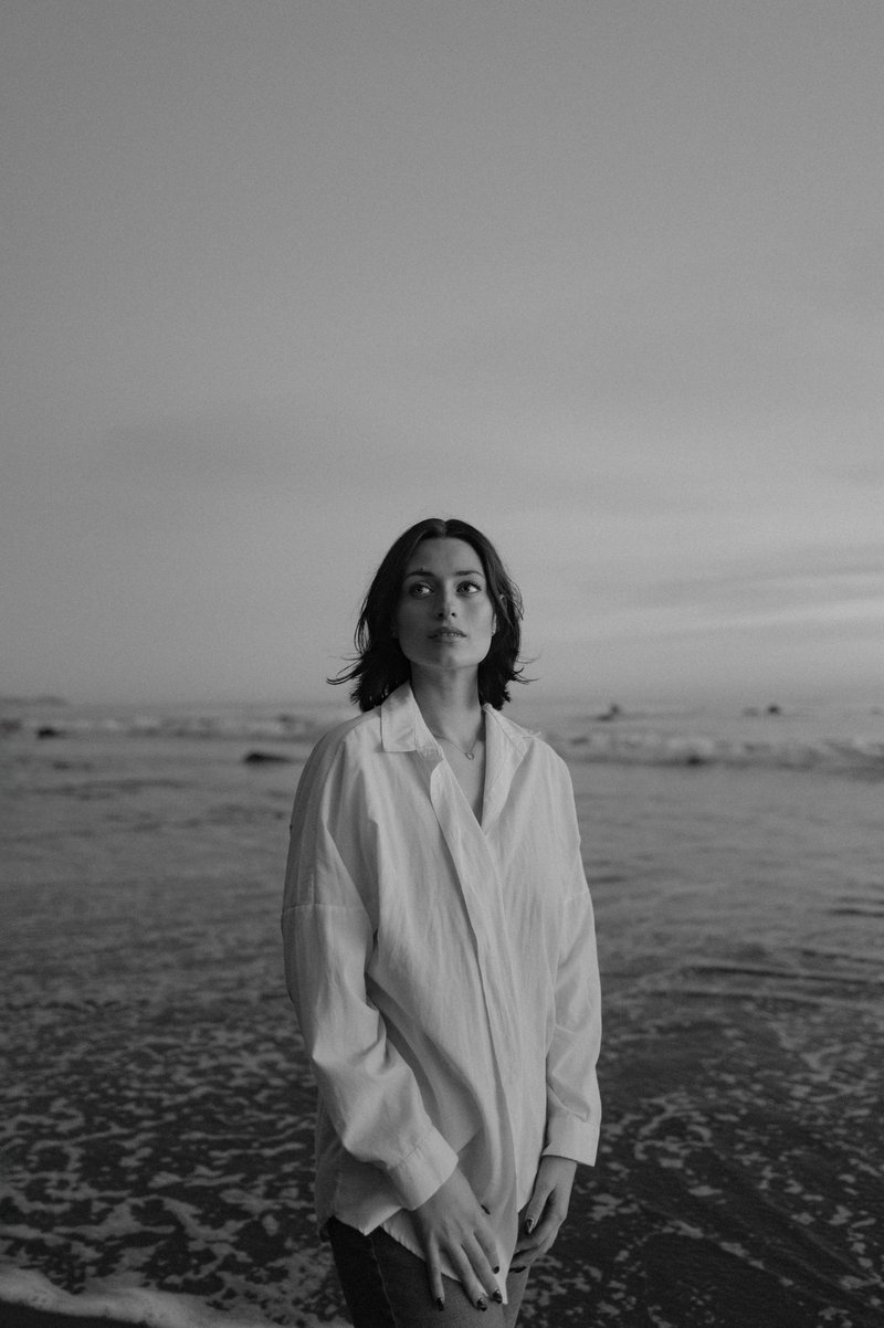 Woman stands alone at the ocean's edge - Free Photo on Unsplash