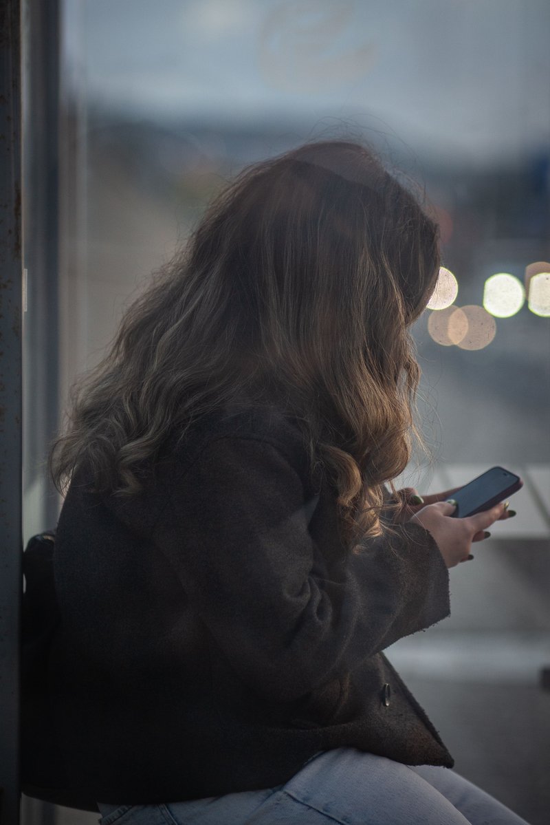 Young Woman Using Smartphone at Bus Stop in Eskişehir · Free ...