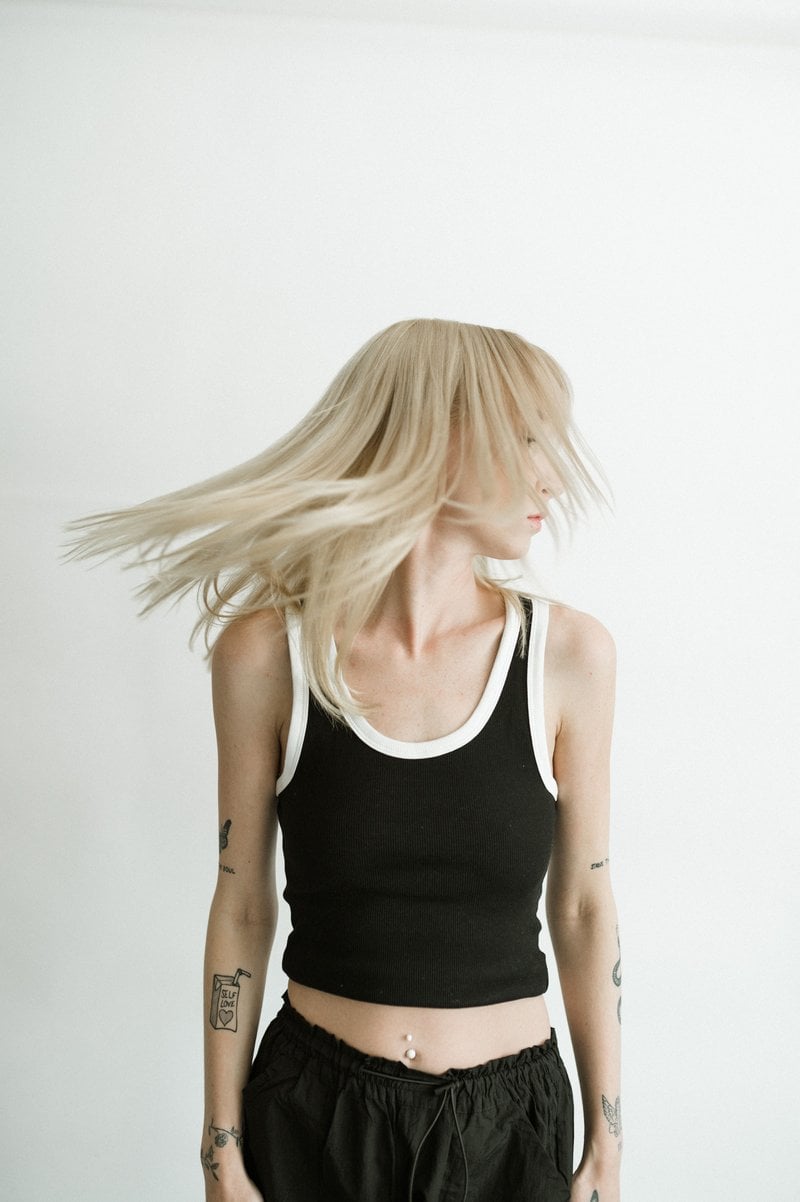 Young Woman with Tattoos Posing in Studio · Free Stock Photo Young Woman with Tattoos Posing in Studio · Free Stock Photo