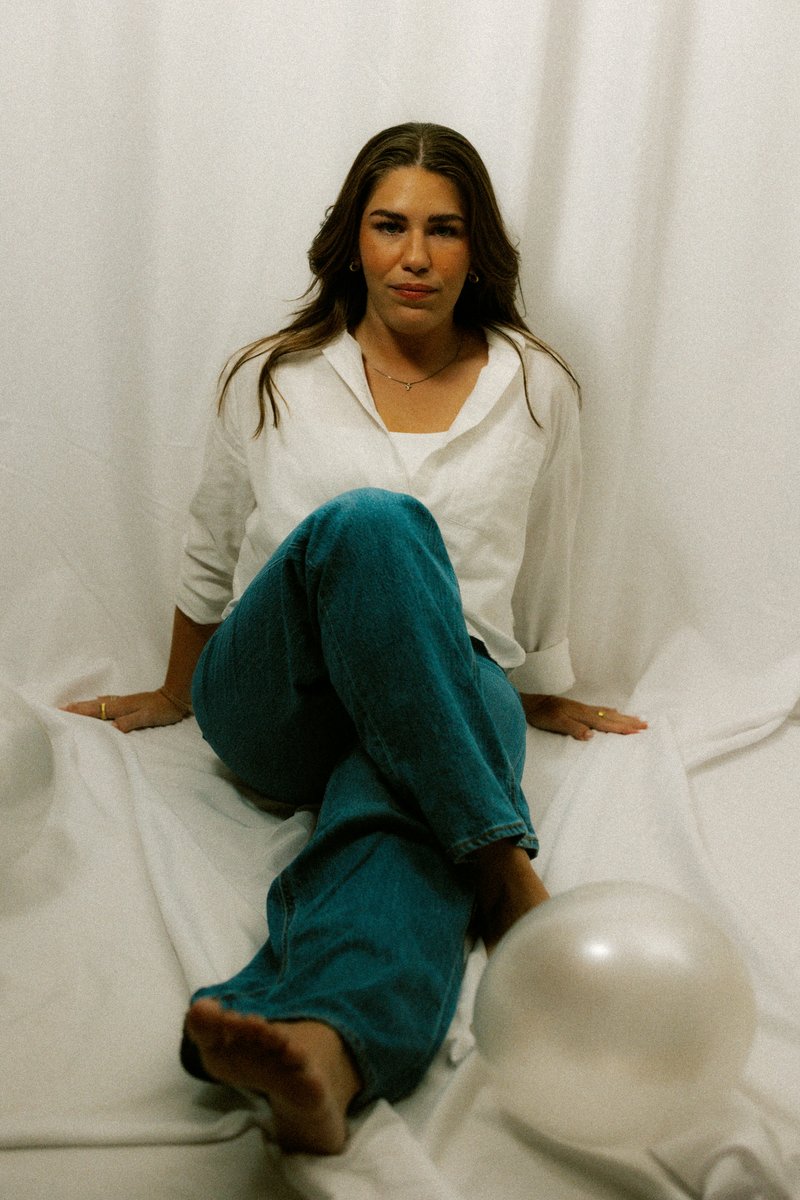 A sad woman sits alone with her arms crossed - Free Photo on ...