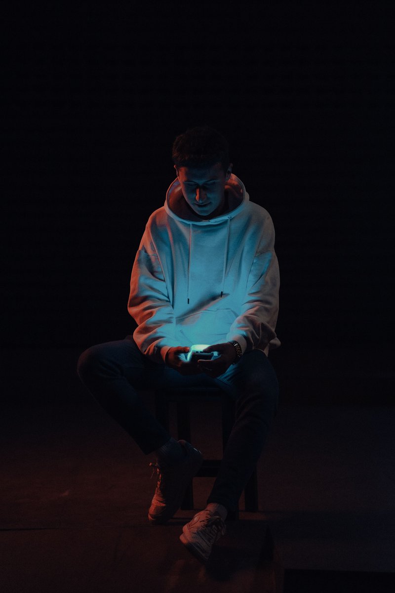 Man Sitting in Darkness Using a Smart Phone &middot; Free Stock Photo