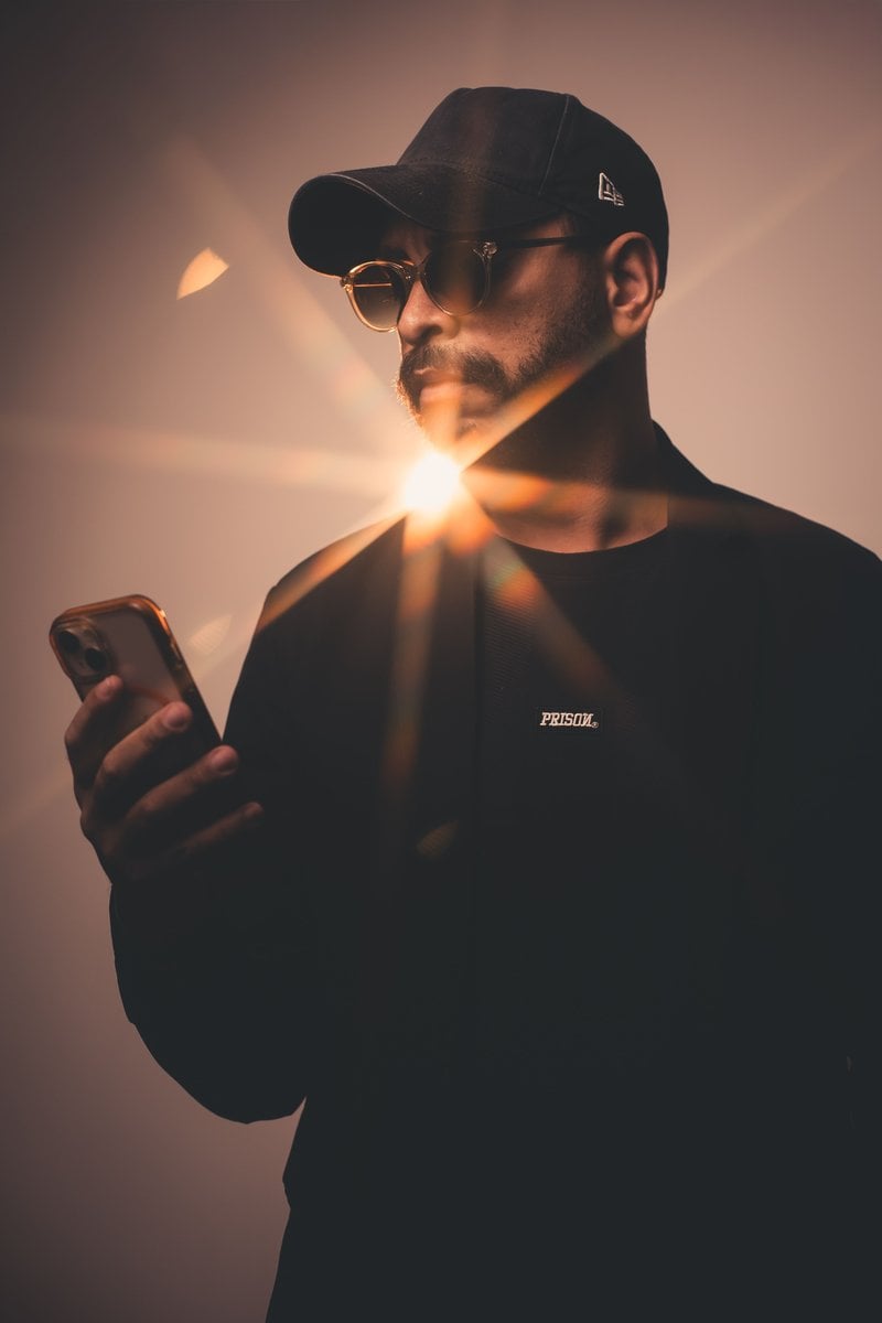 Man Using Cellphone in Dark Train · Free Stock Photo