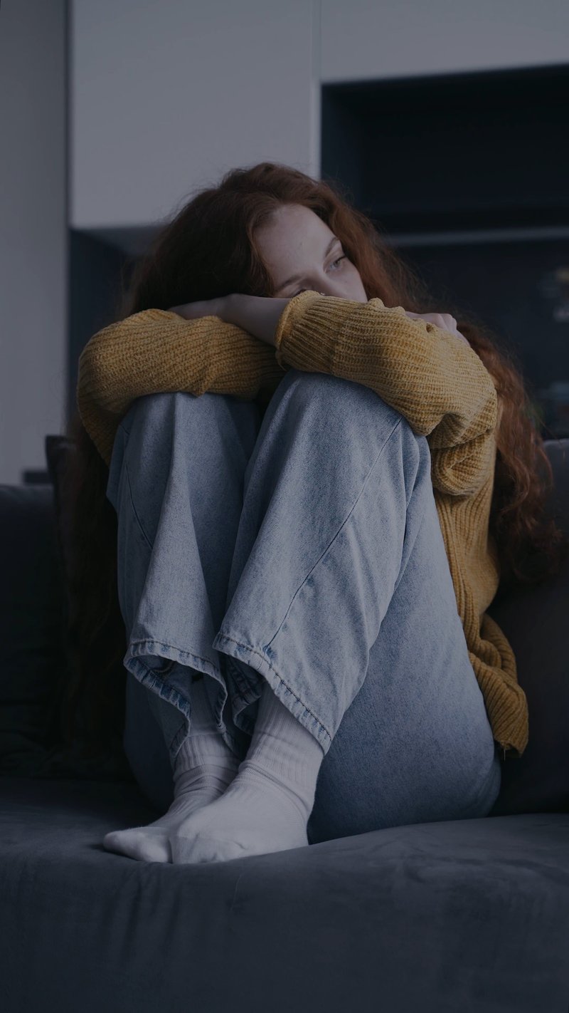 Sad Woman Sitting on the Sofa