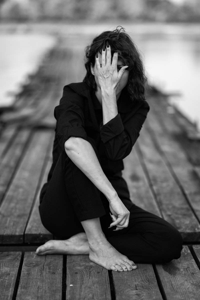 Sad Woman in Dress Sitting on Wooden Plank · Free Stock Photo