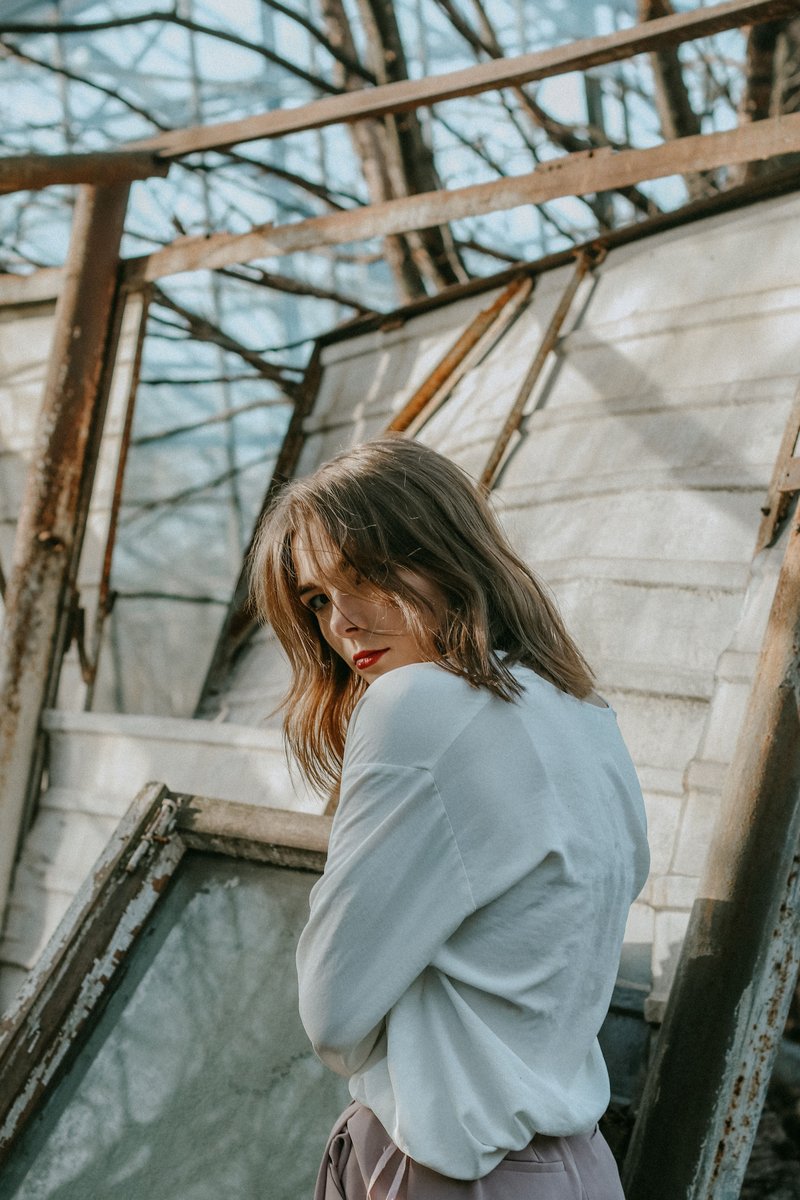 Woman Wearing White Long-sleeved Top Standing on Broken Panel Board &middot; Free  Stock Photo