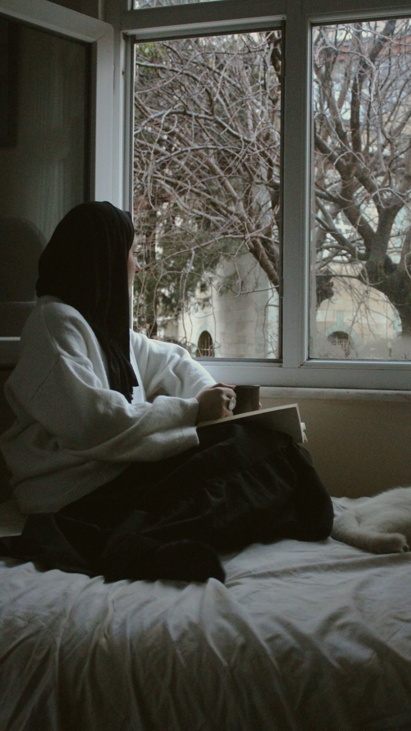 Woman in Hijab Sitting on Bed by Windows &middot; Free Stock Photo