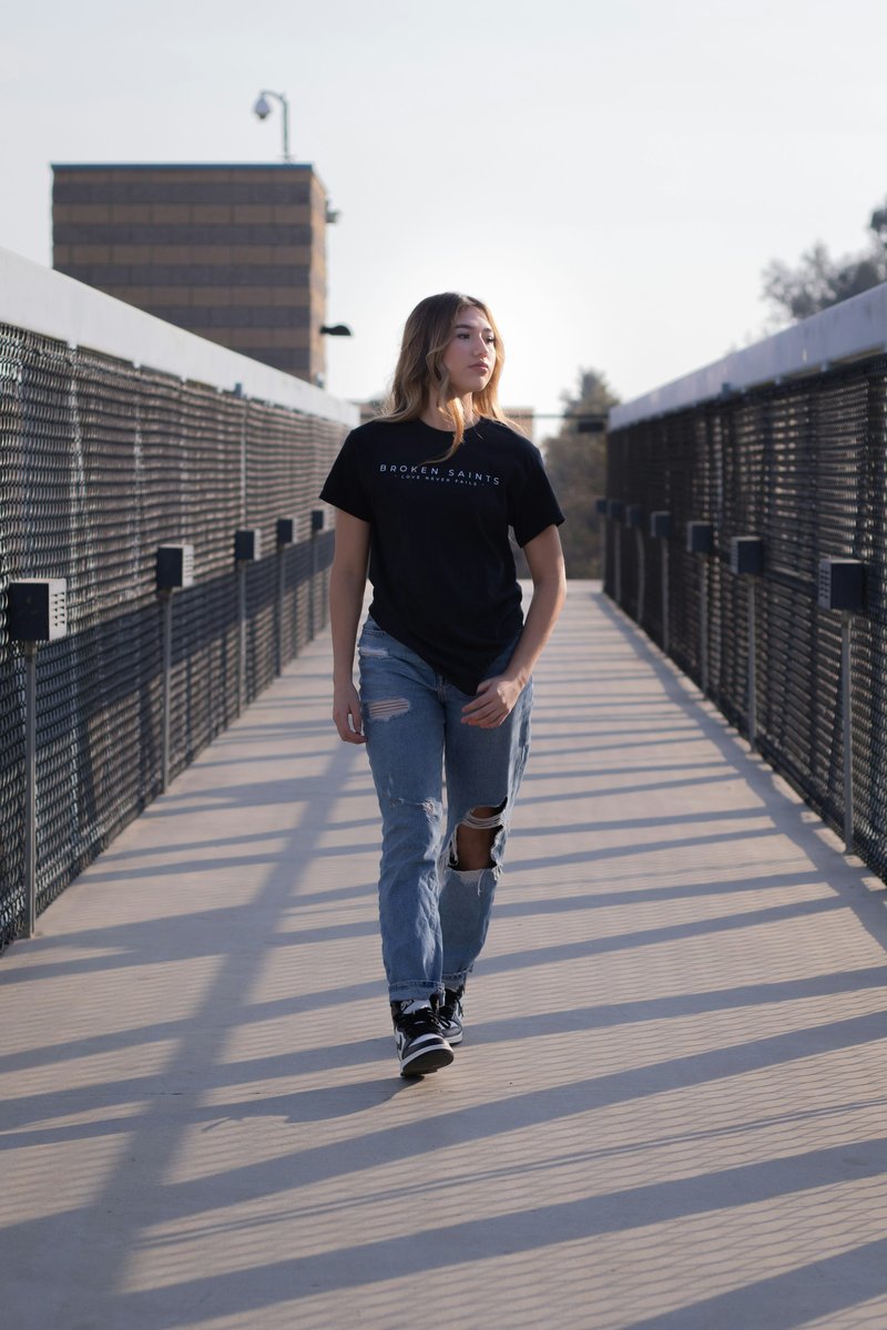 Woman in black crew neck t-shirt and blue denim jeans ...